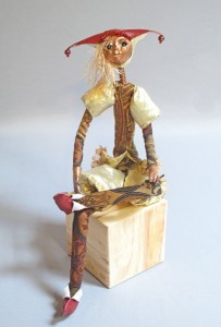 seated art doll titled Nobody's Fool