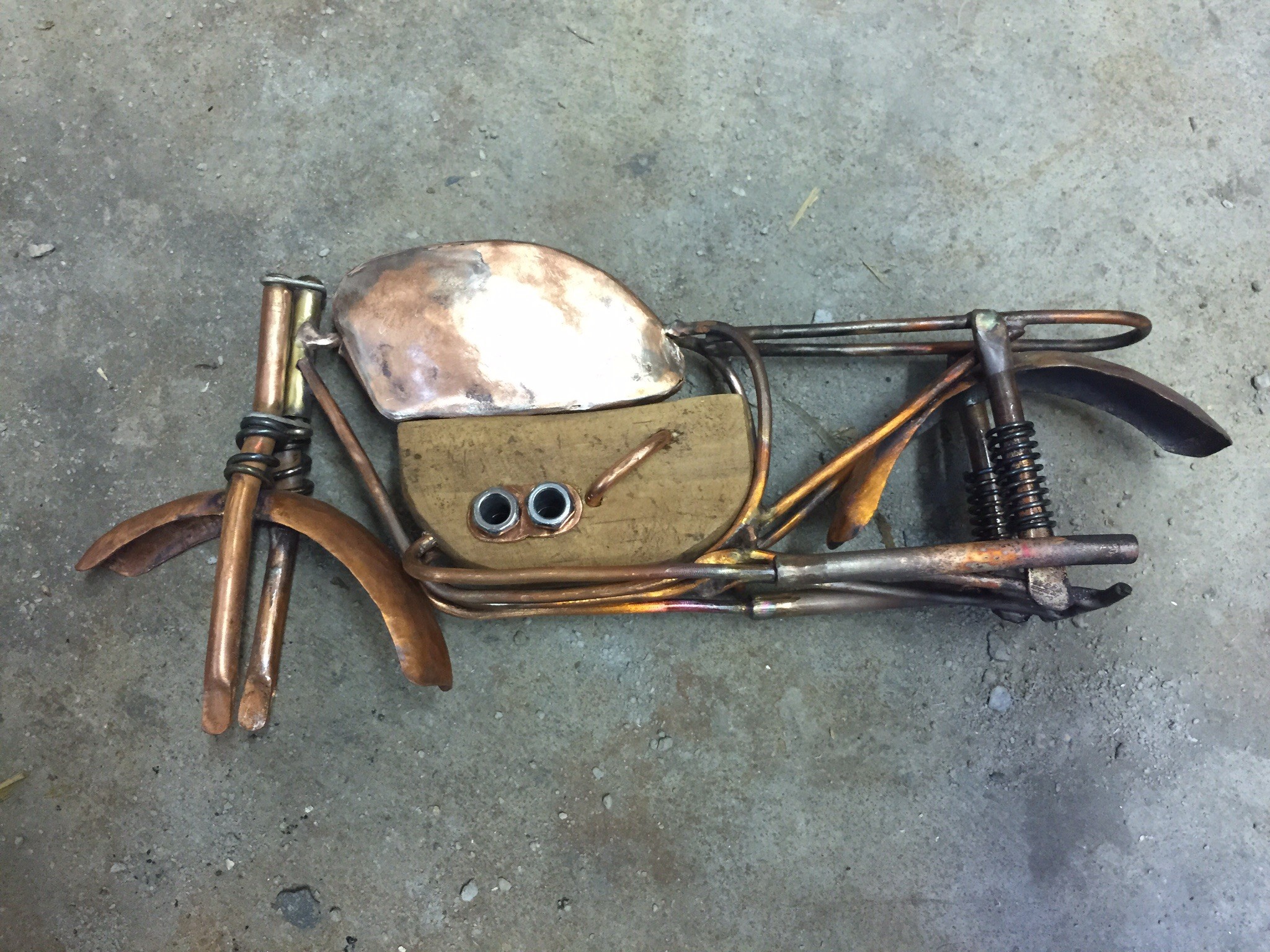 Art doll motorcycle gains gas tank and motor