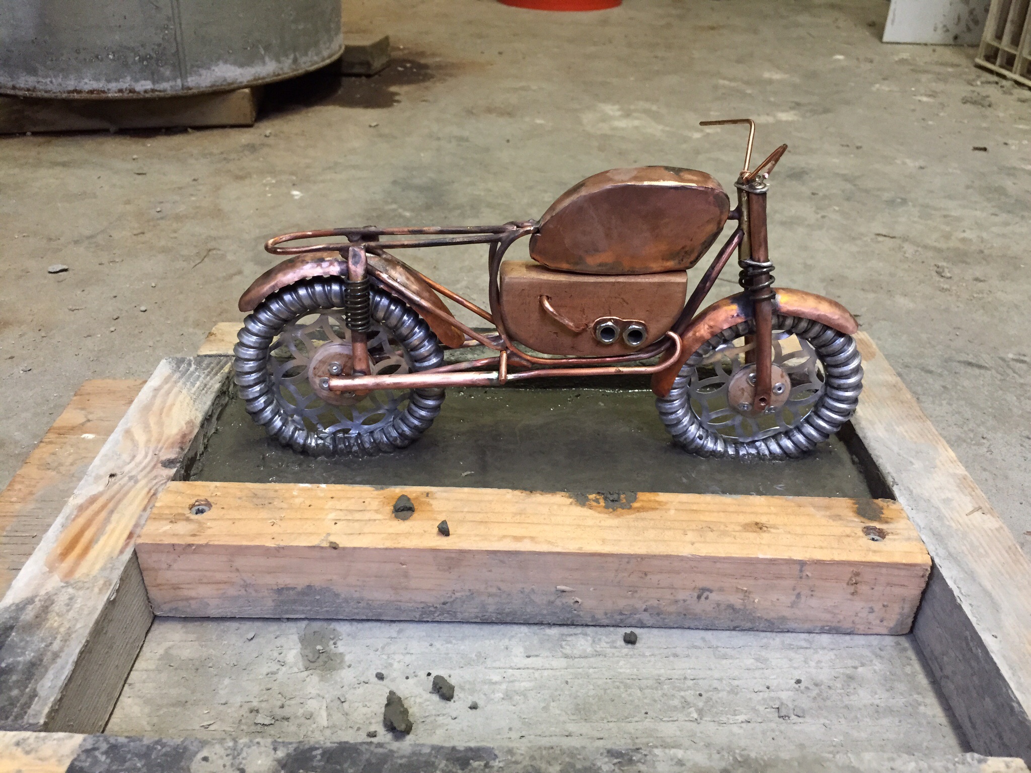 Art doll motorcycle set in concrete base