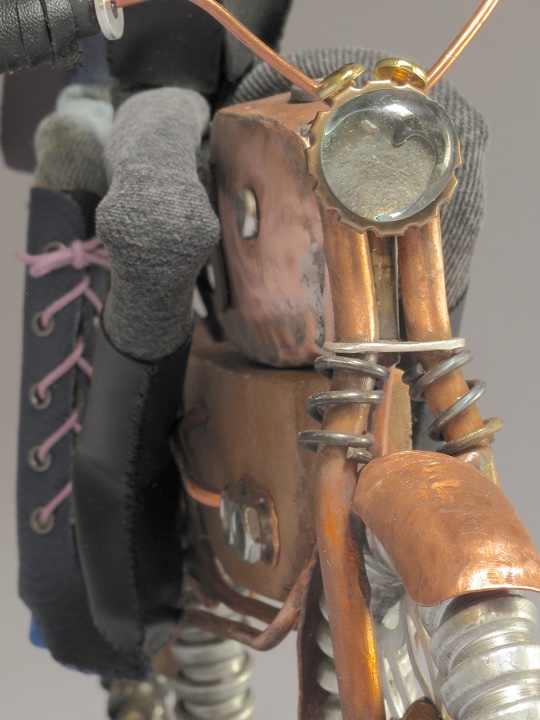 Close up of front of art doll motorcycle