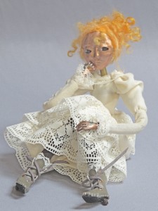 seated art doll figure sculpture titled Girl with the Curl