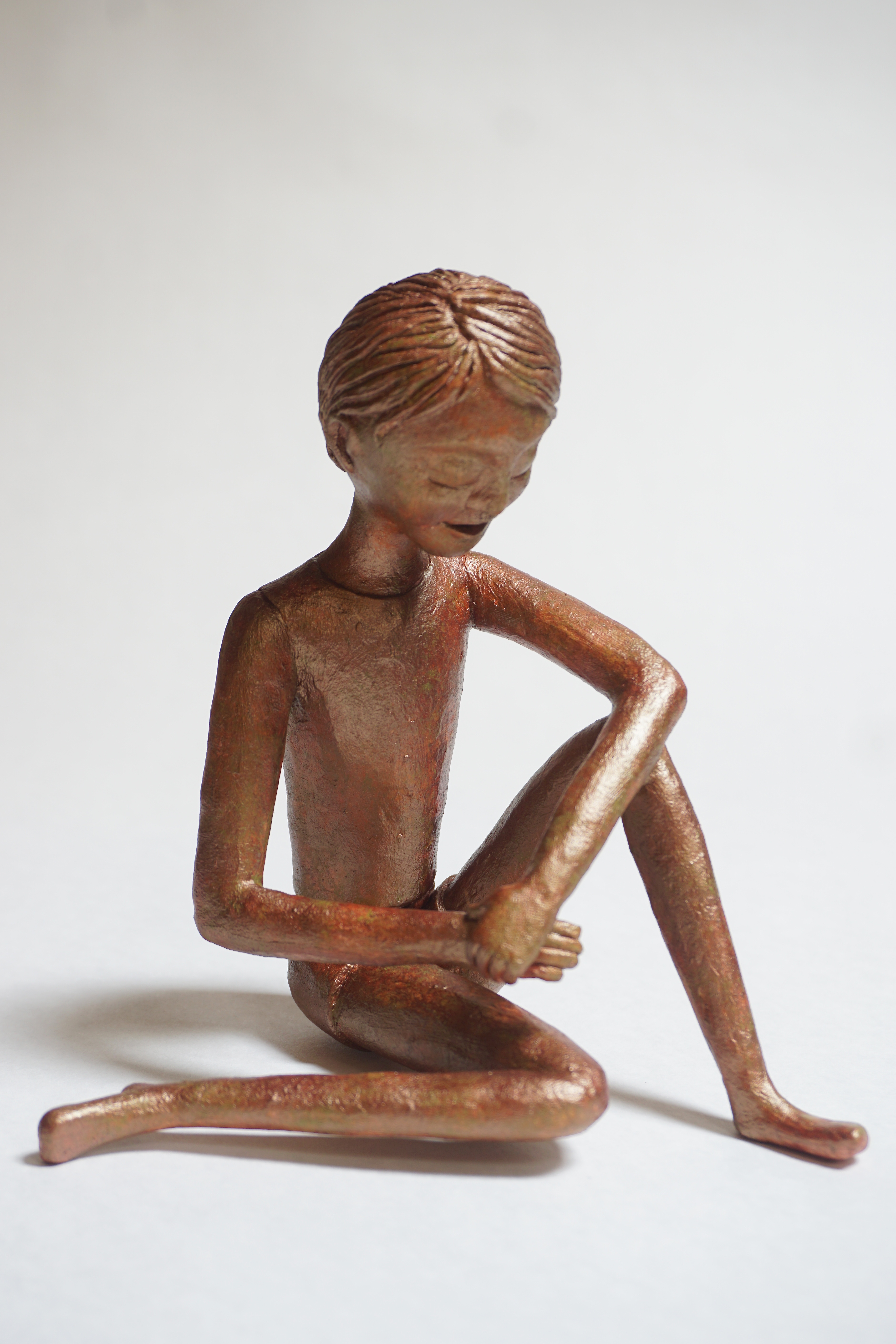 Seated figure with faux bronze finish