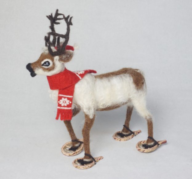 Feet on the Ground is an anthropomorphic reindeer wearing snowshoes art doll holiday sculpture