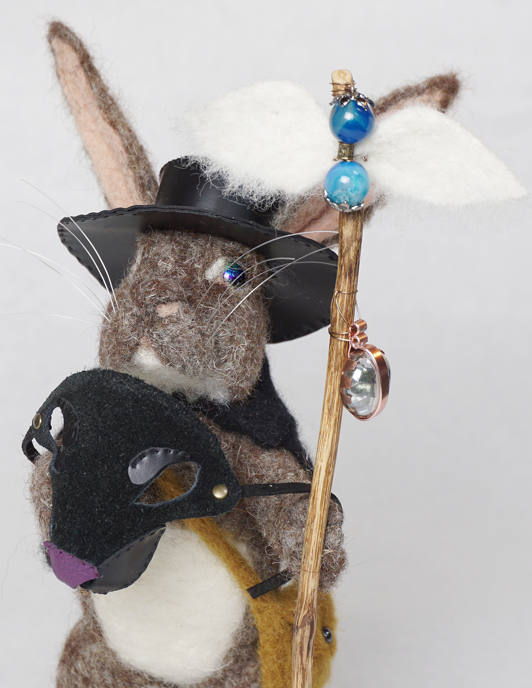 What's Up Doc is an anthropomorphic rabbit plague doctor art doll sculpture. Needle felted wool over wire and batting armature, glass bead, faux leather and suede embellishment.