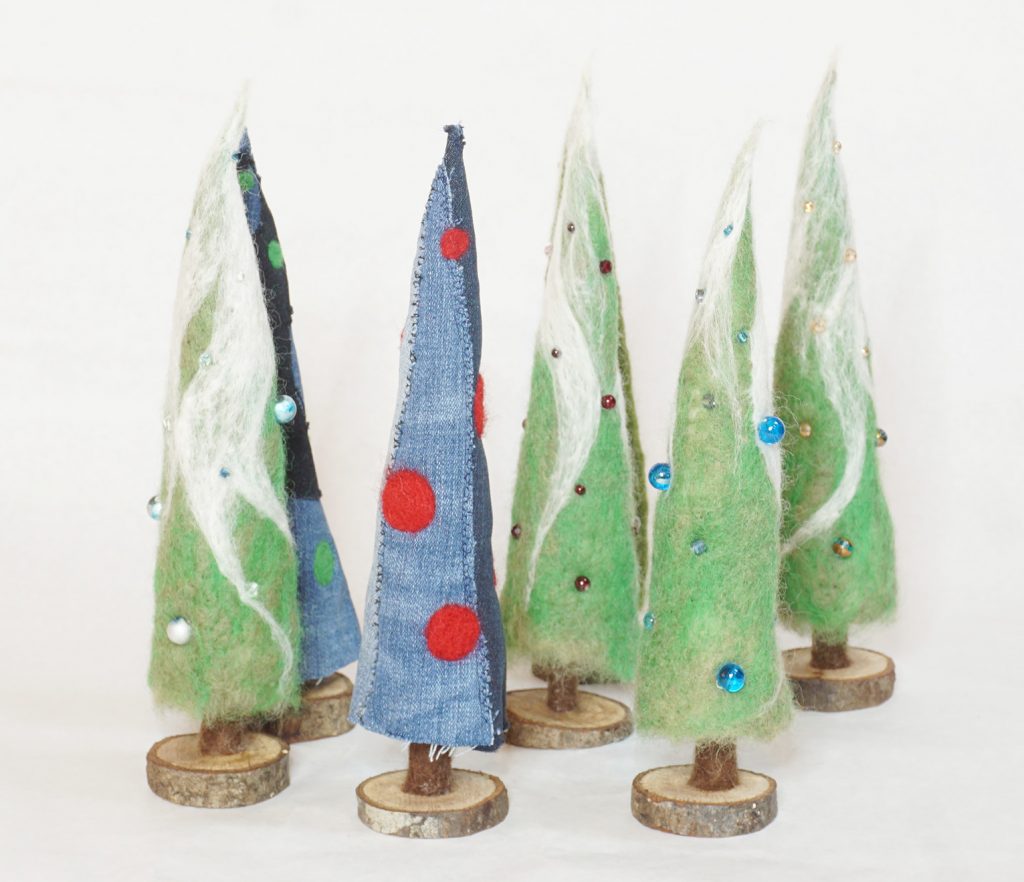 A selection of Lynn's trees for the holidays. needle felted wool with glass beads, or upcycled denim with felted embellishment