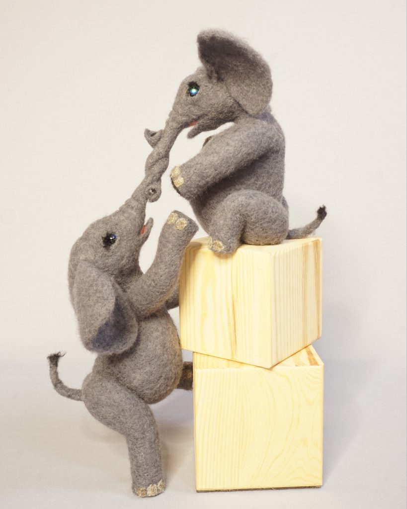 Anthropomorphic elephant pair helping each other climb. needle felted wool art doll figure sculpture