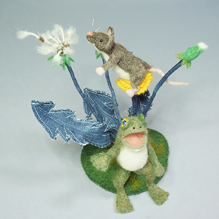 Sculpture of Frog and Mouse singing and wishing on a dandelion. Needle felted wool and recycled denim over wire and batting.