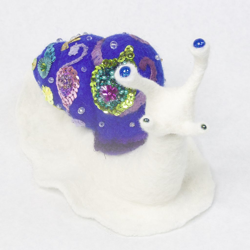 needle felted anthropomorphic snail sculpture with highly embellished shell bling