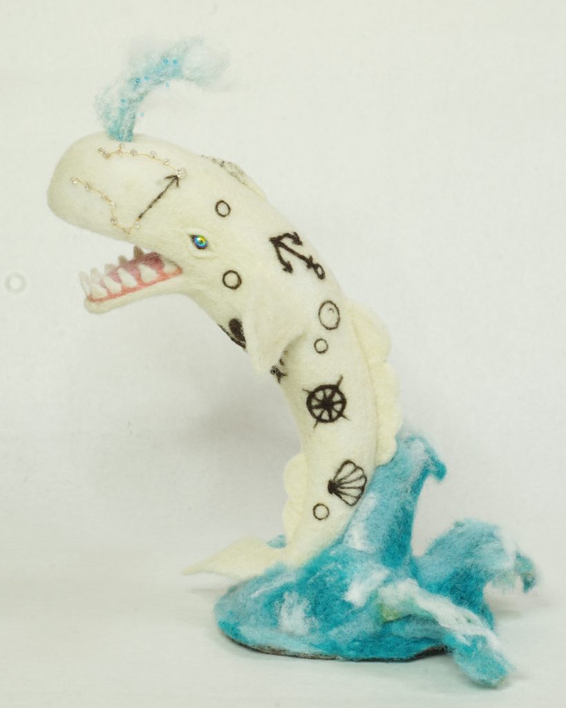 Finding True North - sculpture of breaching and spouting sperm whale with nautical "tattoo" imagery - needle felted wool over wire and batting armature