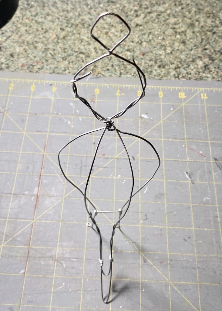 wire armature of queen bee figure.