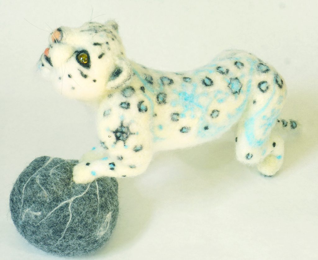 anthropomorphic snow leopard sculpture needle felted wool over wire and batting armature, with "snow" leopard patterning. made artist try more reverse felting