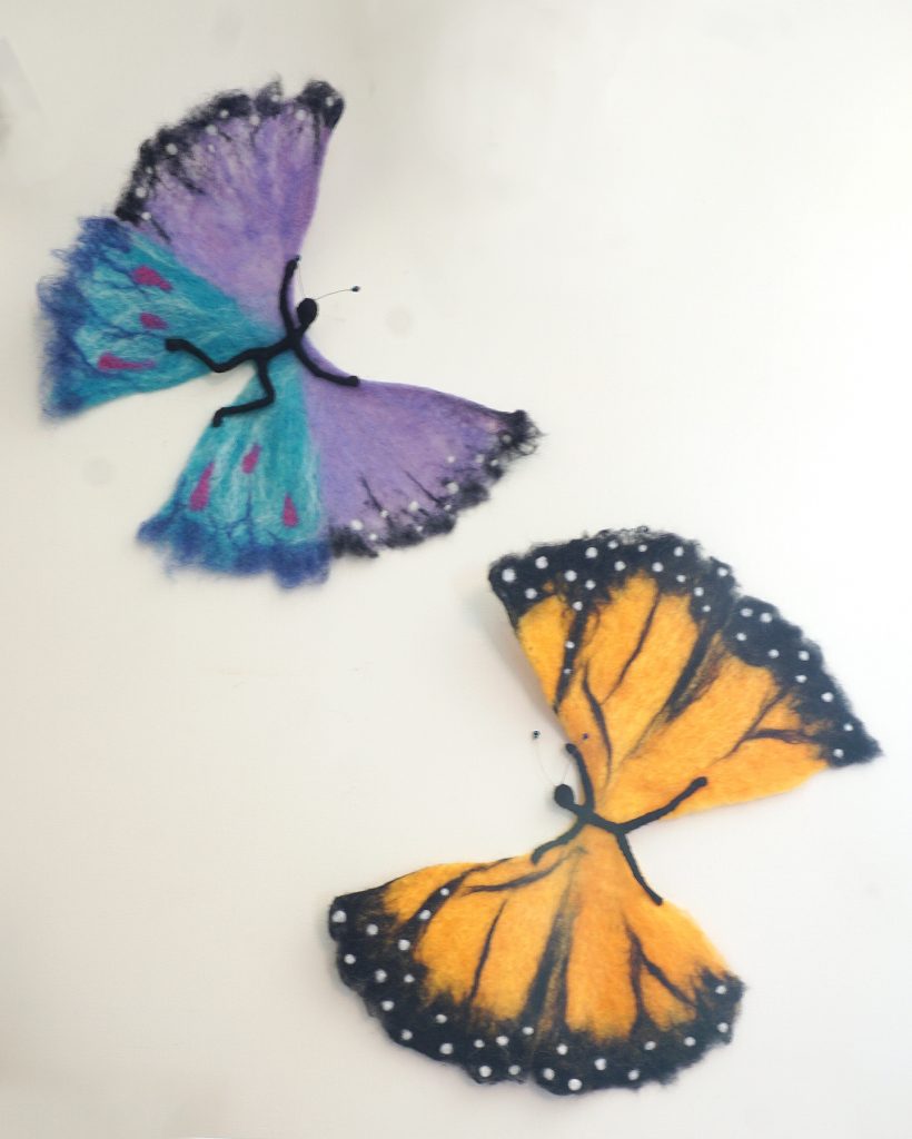 anthropomorphic butterly/human hybrid wall sculptures. Needle felted and wet felted elements