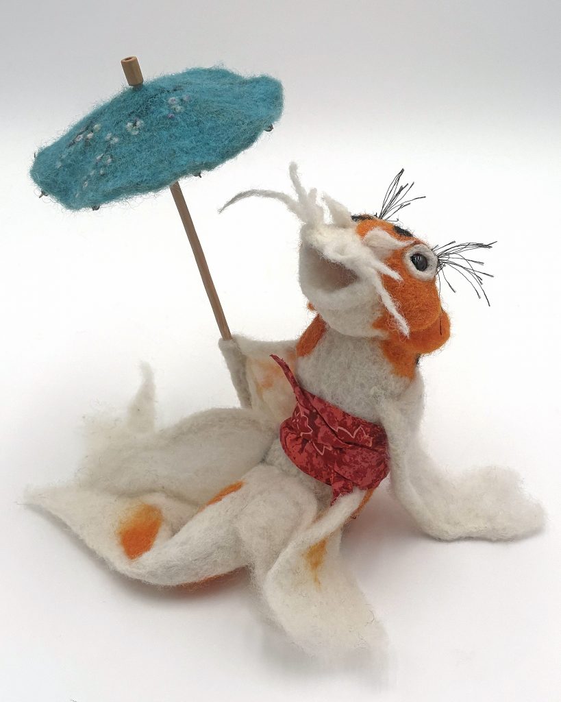 Fish Out Of Water - rework of earlier sculpture. Seated koi figure with parasol, needle felted sculpture by Lynn Wartski