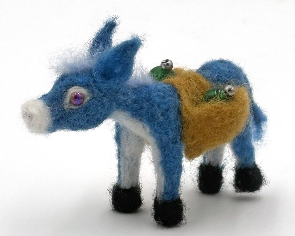 needle felted one-of-a-kind holiday ornament by Lynn Wartski. Blue and white donkey with saddle bags holding glass bead ornaments